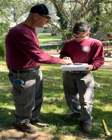 A team member with Wayne discussing a tree planting in Elk Grove, CA